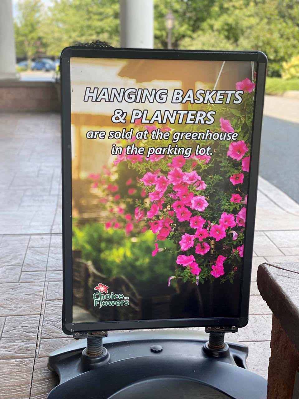A sidewalk A-frame sign Weber designed and printed, set out front of a store