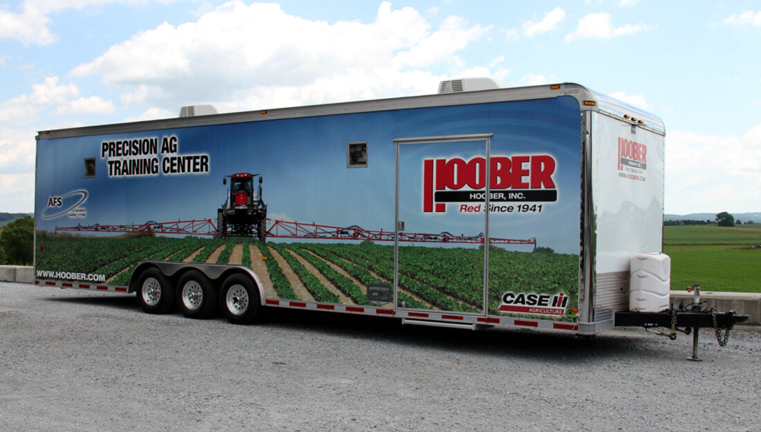 A training trailer wrapped end to end in full-length vinyl graphics designed, printed, and installed by Weber