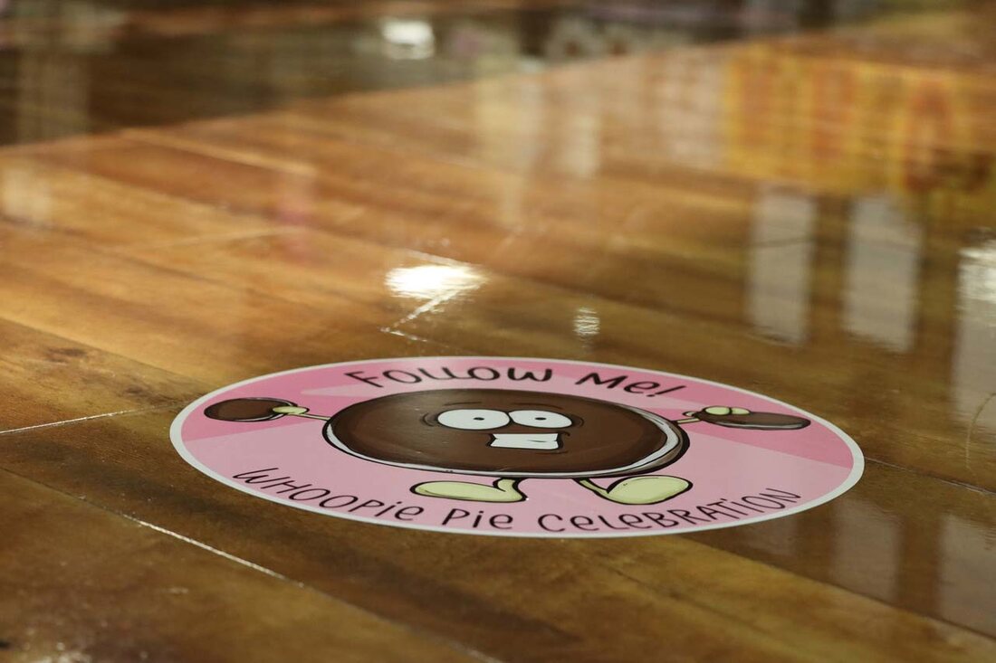 A round whoopie pie floor graphic installed on a polished store floor, printed with a non-slip laminate by Weber